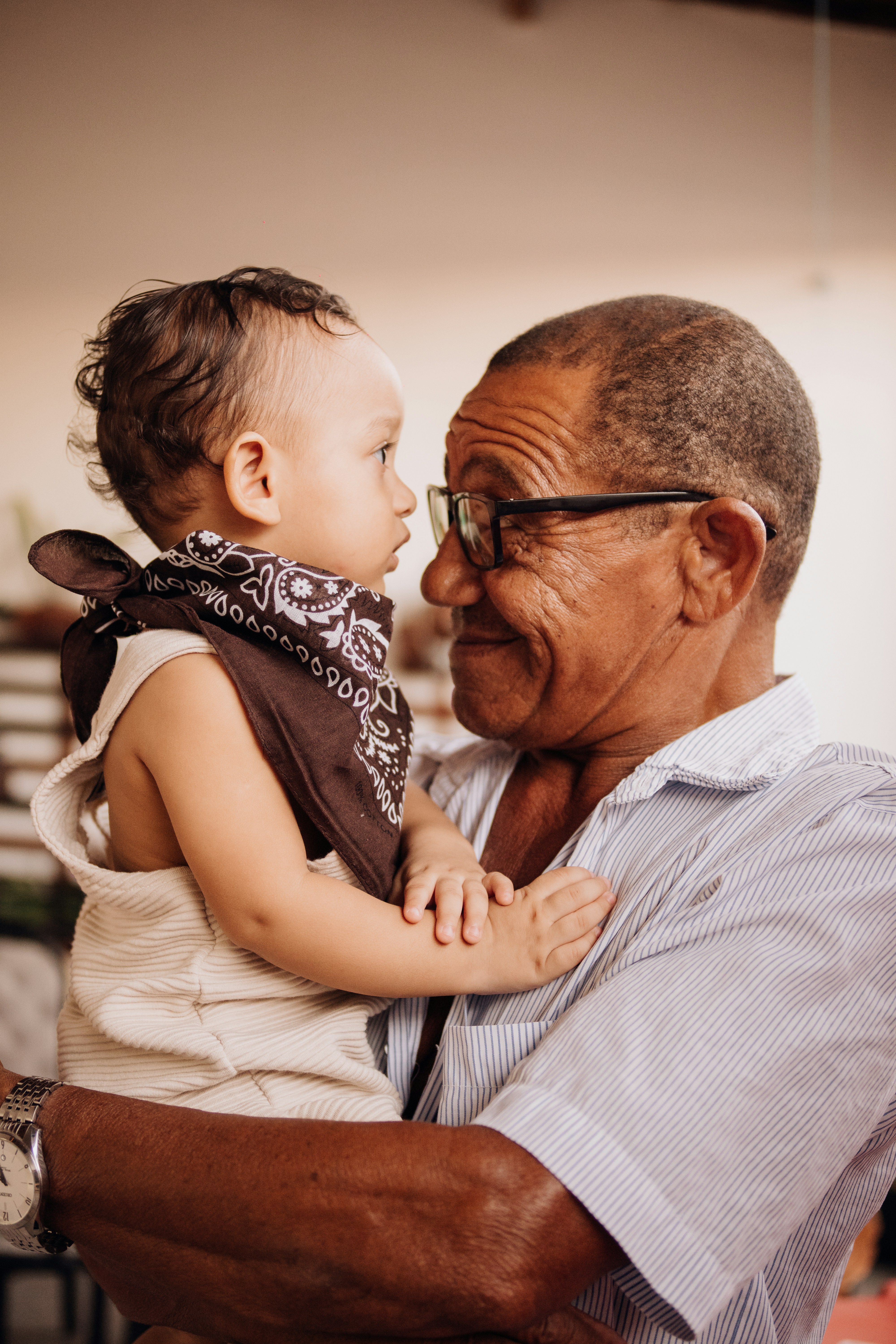 A grandfather lovingly holds his grandchild